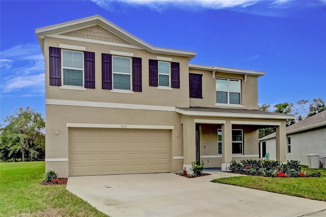 33351 Apricot Tree Ct, Wesley Chapel, FL 33543 - view of front of property featuring a garage, a front yard, a porch, concrete driveway, and stucco siding