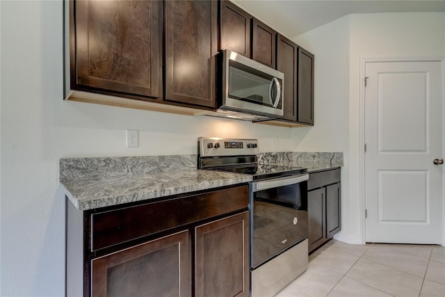 33351 Apricot Tree Ct, Wesley Chapel, FL 33543 - kitchen featuring stainless steel appliances, dark brown cabinets, light tile patterned floors, and light countertops