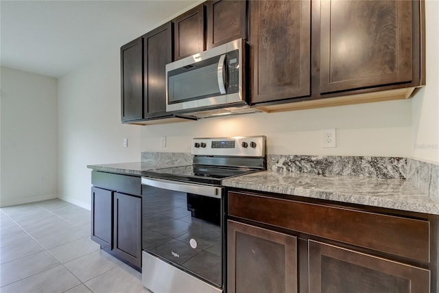 33351 Apricot Tree Ct, Wesley Chapel, FL 33543 - kitchen featuring appliances with stainless steel finishes, dark brown cabinets, light tile patterned floors, and light countertops