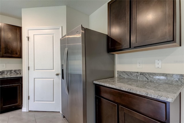 33351 Apricot Tree Ct, Wesley Chapel, FL 33543 - kitchen with stainless steel refrigerator with ice dispenser, dark brown cabinets, and light tile patterned floors