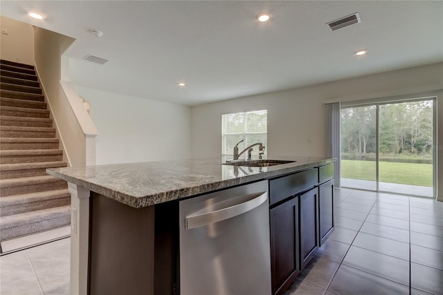 33351 Apricot Tree Ct, Wesley Chapel, FL 33543 - kitchen featuring stainless steel dishwasher, light tile patterned floors, a kitchen island with sink, stone counters, and recessed lighting