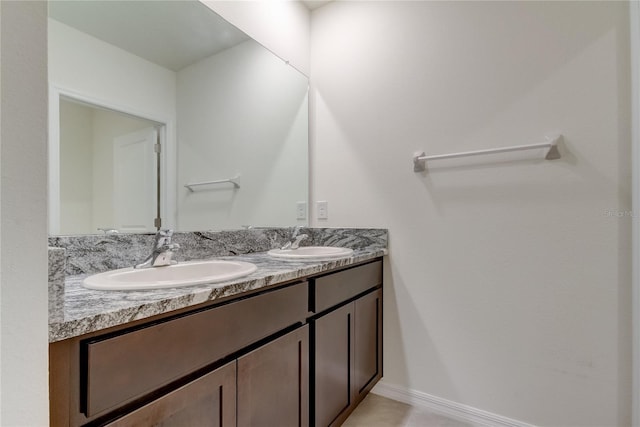 33351 Apricot Tree Ct, Wesley Chapel, FL 33543 - full bathroom featuring double vanity and baseboards