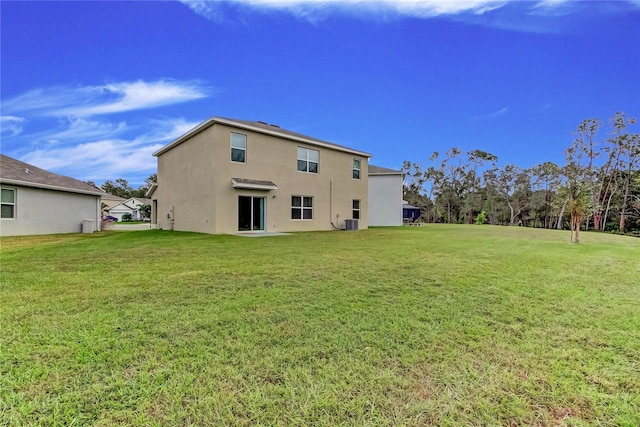 33351 Apricot Tree Ct, Wesley Chapel, FL 33543 - rear view of house with stucco siding and a lawn
