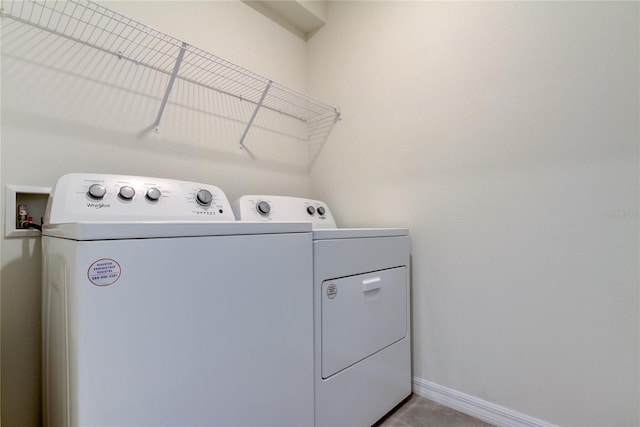 33351 Apricot Tree Ct, Wesley Chapel, FL 33543 - washroom featuring washing machine and clothes dryer and tile patterned flooring