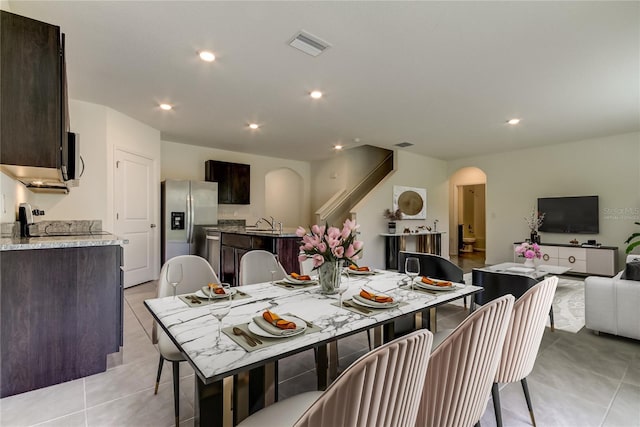 33351 Apricot Tree Ct, Wesley Chapel, FL 33543 - dining space with arched walkways, recessed lighting, and light tile patterned floors