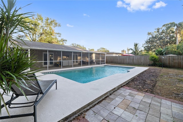 view of swimming pool with a patio area and a sunroom