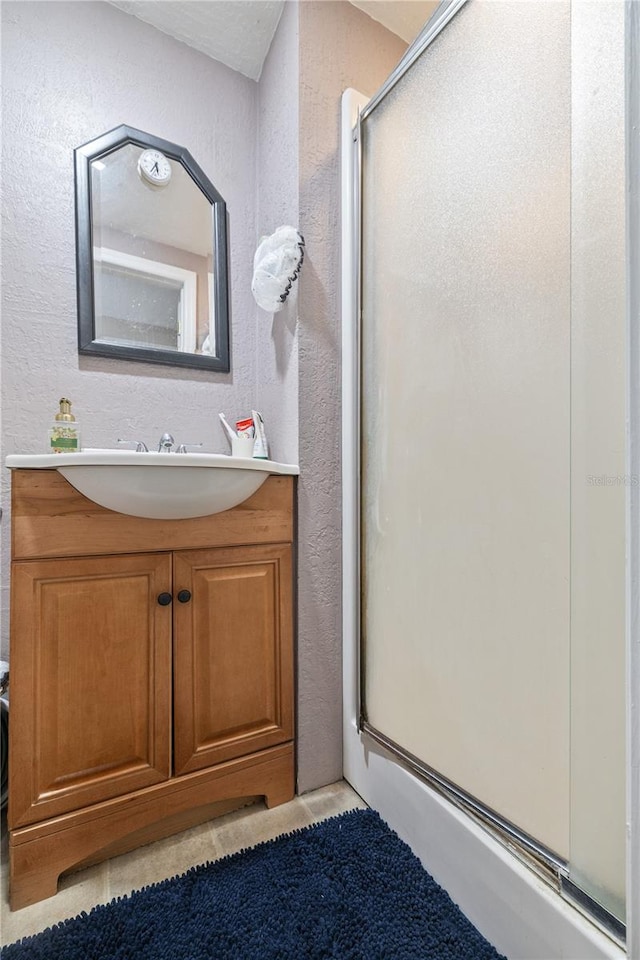 bathroom with vanity and a shower with shower door