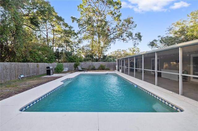 view of pool featuring a patio area and a sunroom