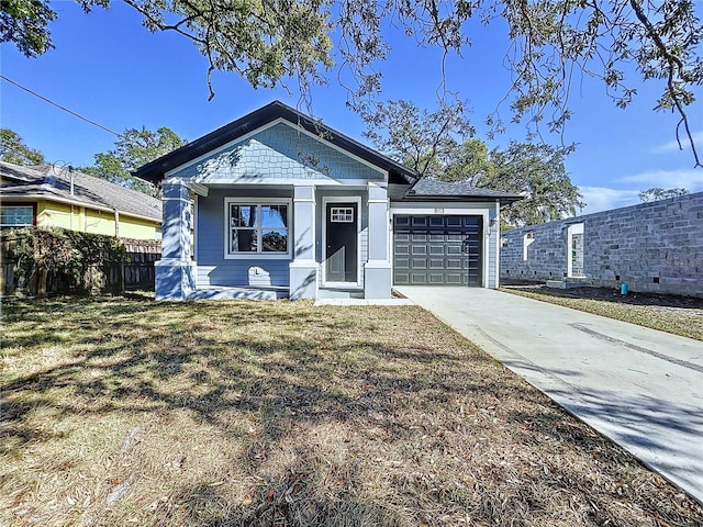 view of front of property with a front lawn and a garage