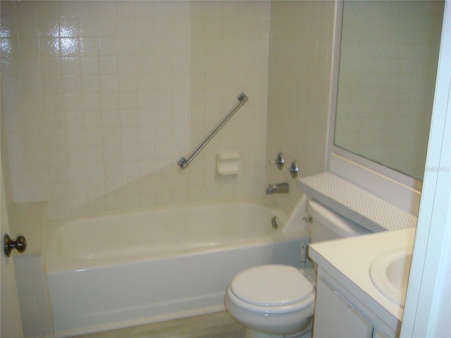 full bathroom featuring tiled shower / bath combo, toilet, wood-type flooring, and vanity