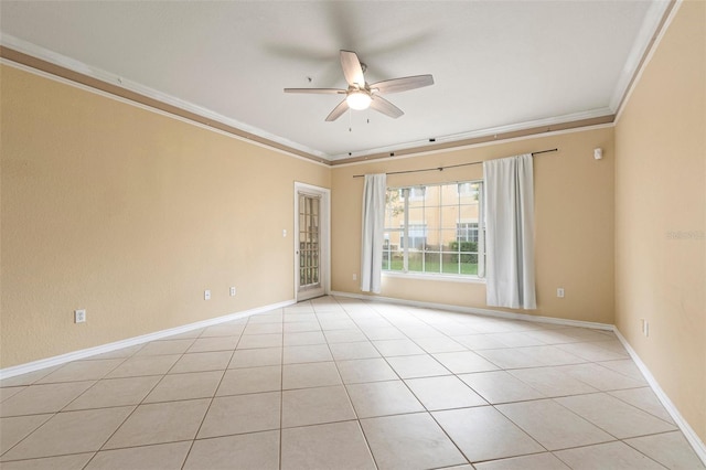 tiled empty room with ceiling fan and ornamental molding