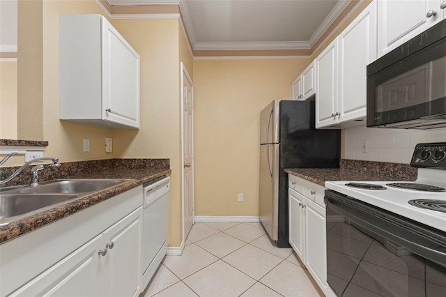 kitchen featuring tasteful backsplash, light tile patterned floors, sink, white cabinets, and white appliances