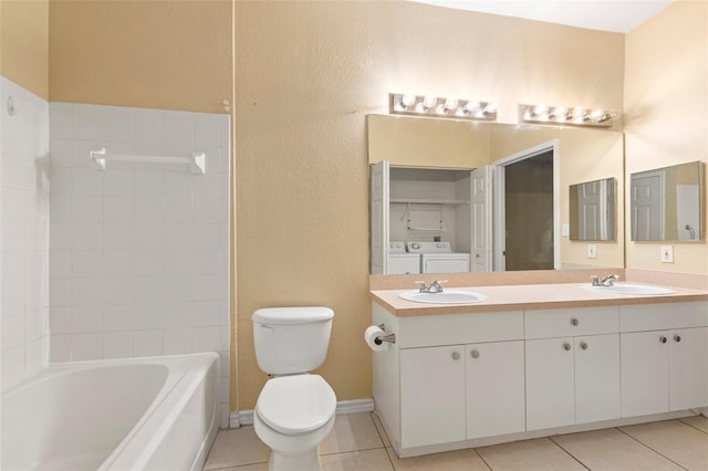 full bathroom featuring toilet, tile patterned flooring, washtub / shower combination, washing machine and clothes dryer, and vanity