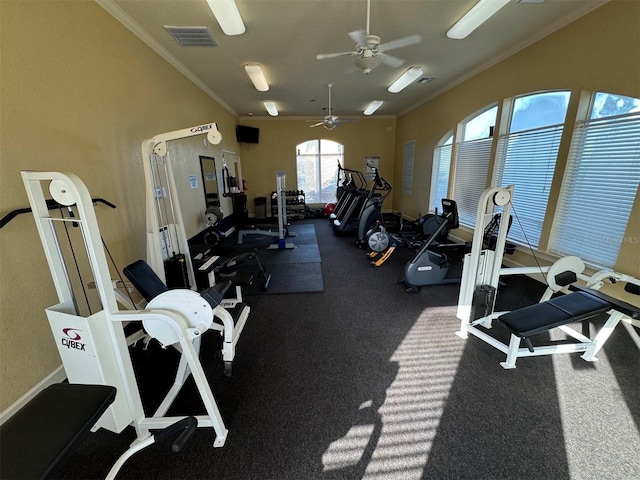 gym with ceiling fan and crown molding