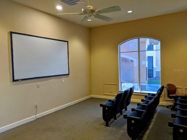 home theater with ceiling fan and carpet flooring