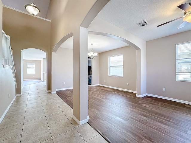 interior space with light wood-type flooring, an inviting chandelier, and a healthy amount of sunlight