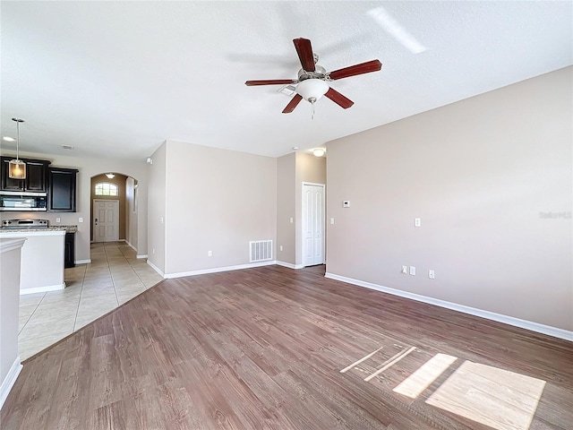 unfurnished living room featuring light hardwood / wood-style floors and ceiling fan