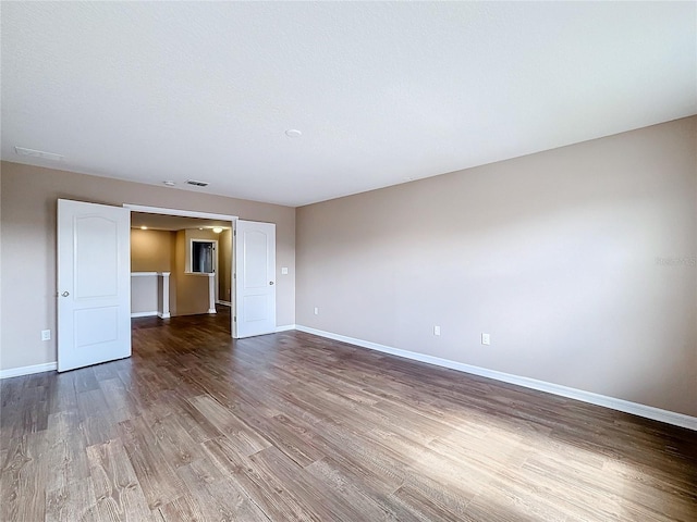 unfurnished room with wood-type flooring