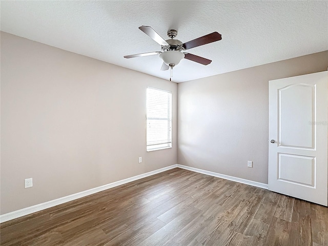 empty room featuring hardwood / wood-style flooring, ceiling fan, and a textured ceiling