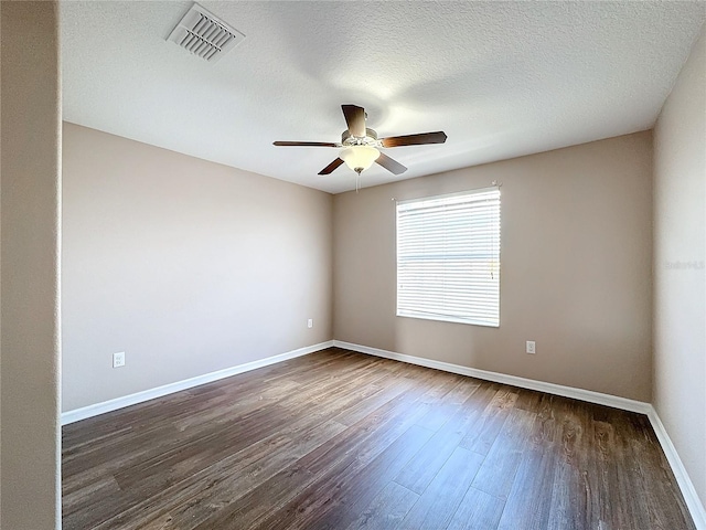 empty room with ceiling fan, a textured ceiling, and dark hardwood / wood-style floors