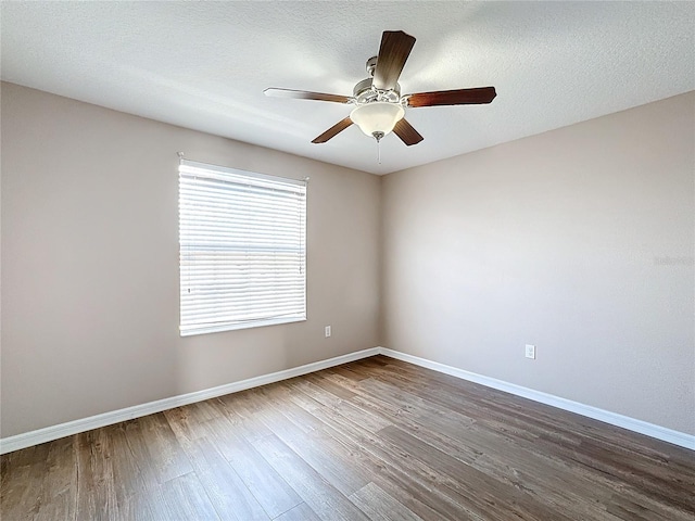 unfurnished room featuring ceiling fan, wood-type flooring, and a textured ceiling