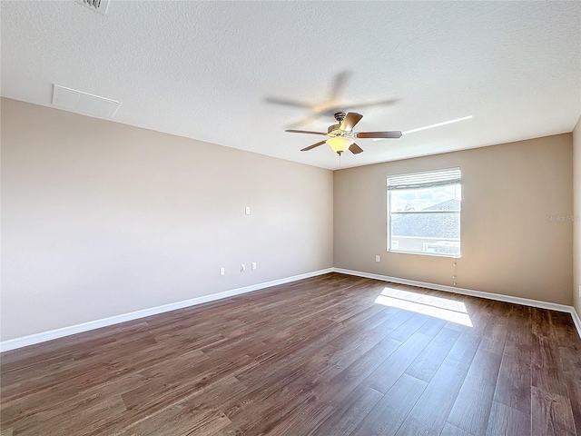 unfurnished room featuring a textured ceiling, dark wood-type flooring, and ceiling fan