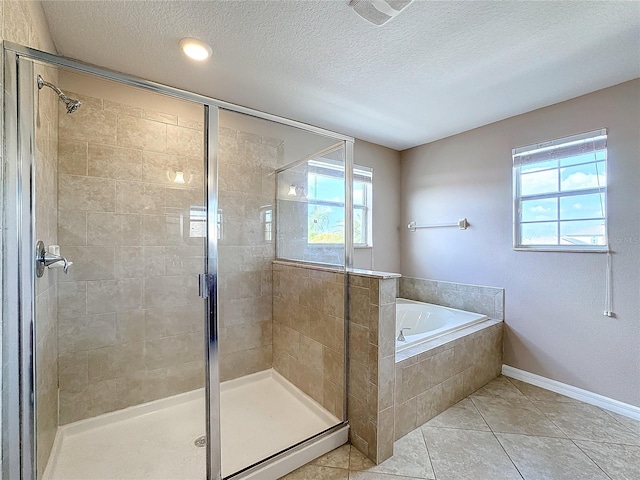 bathroom with plenty of natural light, tile patterned floors, and a textured ceiling