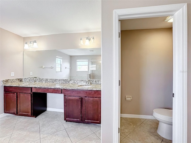 bathroom featuring vanity, tile patterned flooring, and toilet