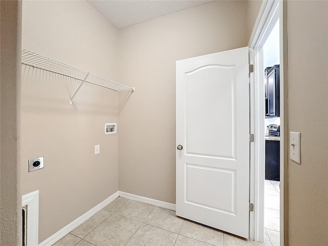 washroom with light tile patterned flooring, hookup for a washing machine, and hookup for an electric dryer