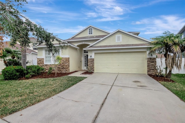 view of front of property featuring a garage and a front lawn