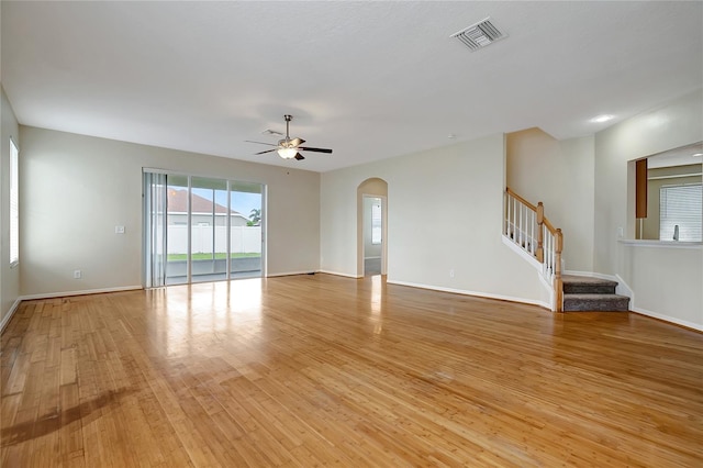 unfurnished living room featuring ceiling fan and light hardwood / wood-style flooring