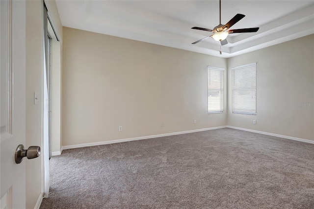 carpeted spare room with ceiling fan