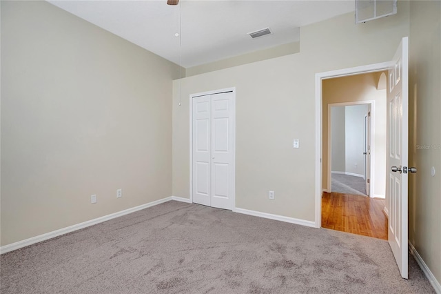 unfurnished bedroom with carpet flooring and a closet