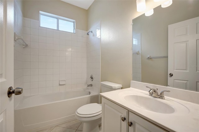 full bathroom featuring tile patterned flooring, tiled shower / bath, toilet, and vanity