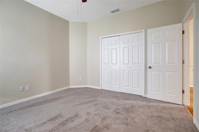 unfurnished bedroom featuring a closet, carpet, and ceiling fan