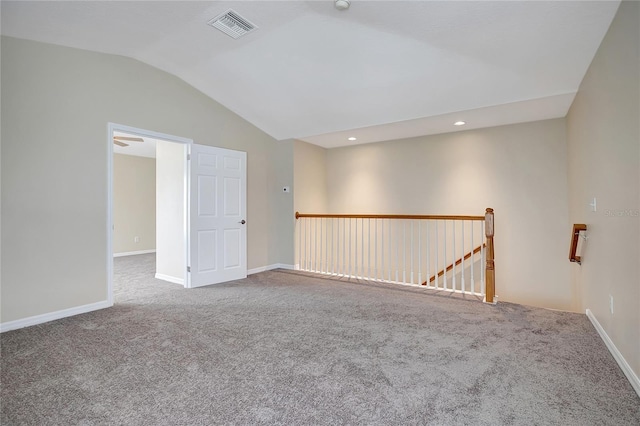 unfurnished room with carpet flooring and vaulted ceiling