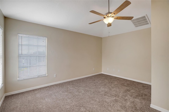 unfurnished room featuring ceiling fan and carpet