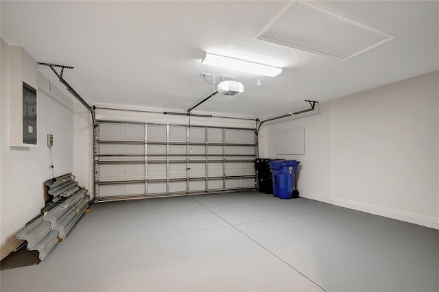 garage with a garage door opener and electric panel