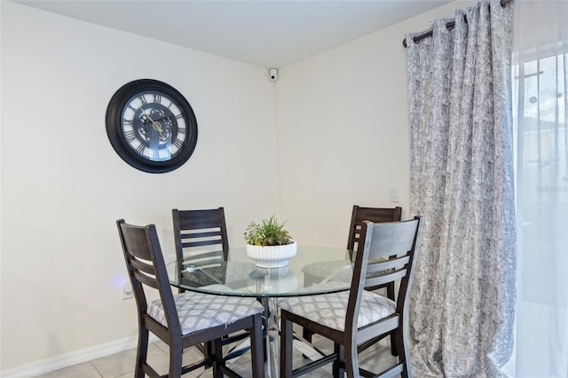 dining area featuring light tile patterned flooring