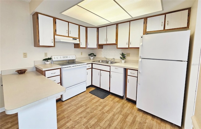 kitchen featuring white appliances, white cabinets, a peninsula, light countertops, and under cabinet range hood