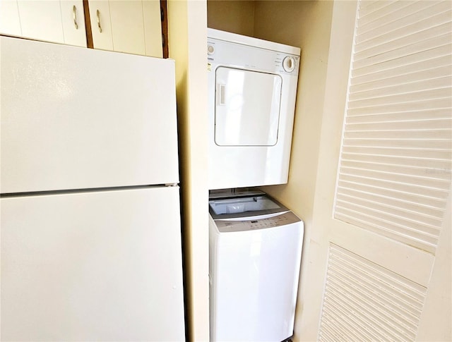 clothes washing area with stacked washer / drying machine