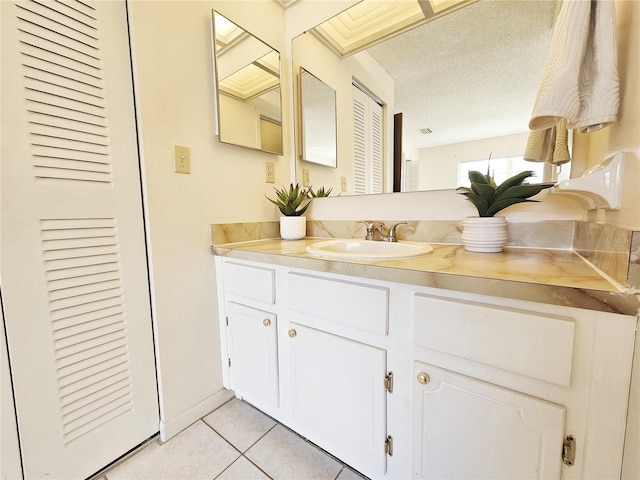 bathroom featuring a textured ceiling, a closet, vanity, and tile patterned floors