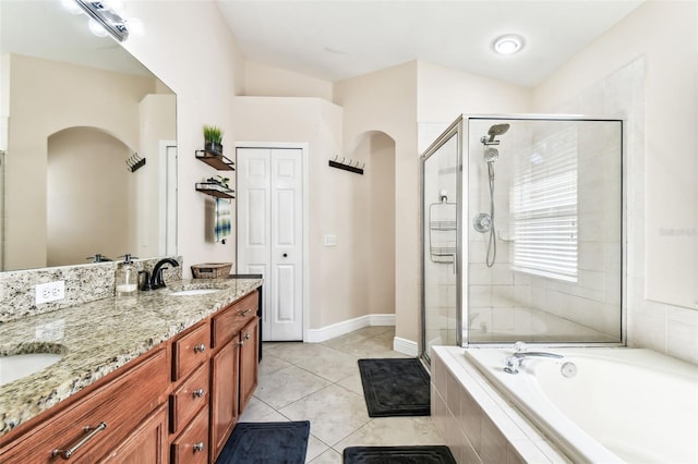 bathroom featuring tile patterned flooring, lofted ceiling, separate shower and tub, and vanity