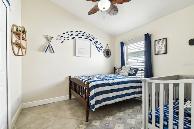 bedroom with ceiling fan, light tile patterned floors, and vaulted ceiling