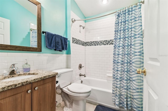 full bathroom featuring shower / bath combo with shower curtain, vanity, tile patterned floors, toilet, and tile walls