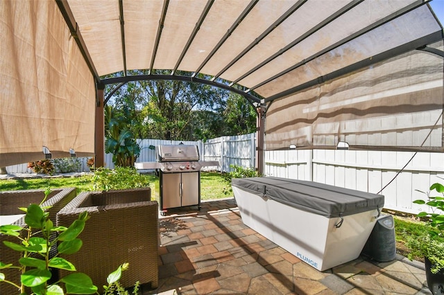 view of patio / terrace featuring a hot tub and a pergola