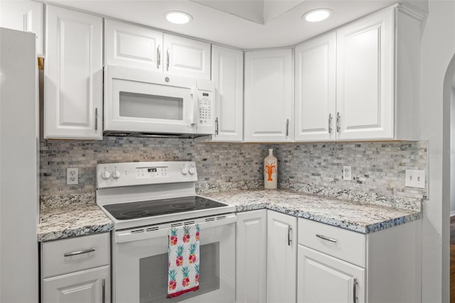 kitchen featuring white cabinetry, white appliances, backsplash, and light stone countertops