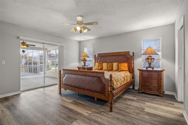 bedroom featuring ceiling fan, dark hardwood / wood-style floors, multiple windows, and access to outside