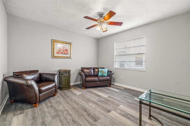 8404 Millwood Dr, Hudson, FL 34667 - sitting room with wood finished floors, a textured ceiling, ceiling fan, and baseboards