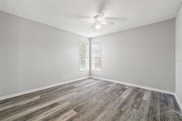 empty room featuring dark hardwood / wood-style flooring, a textured ceiling, and ceiling fan